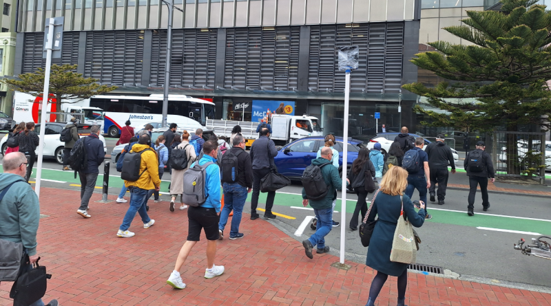 Decorative image showing a large group of pedestrians crossing Bunny Street