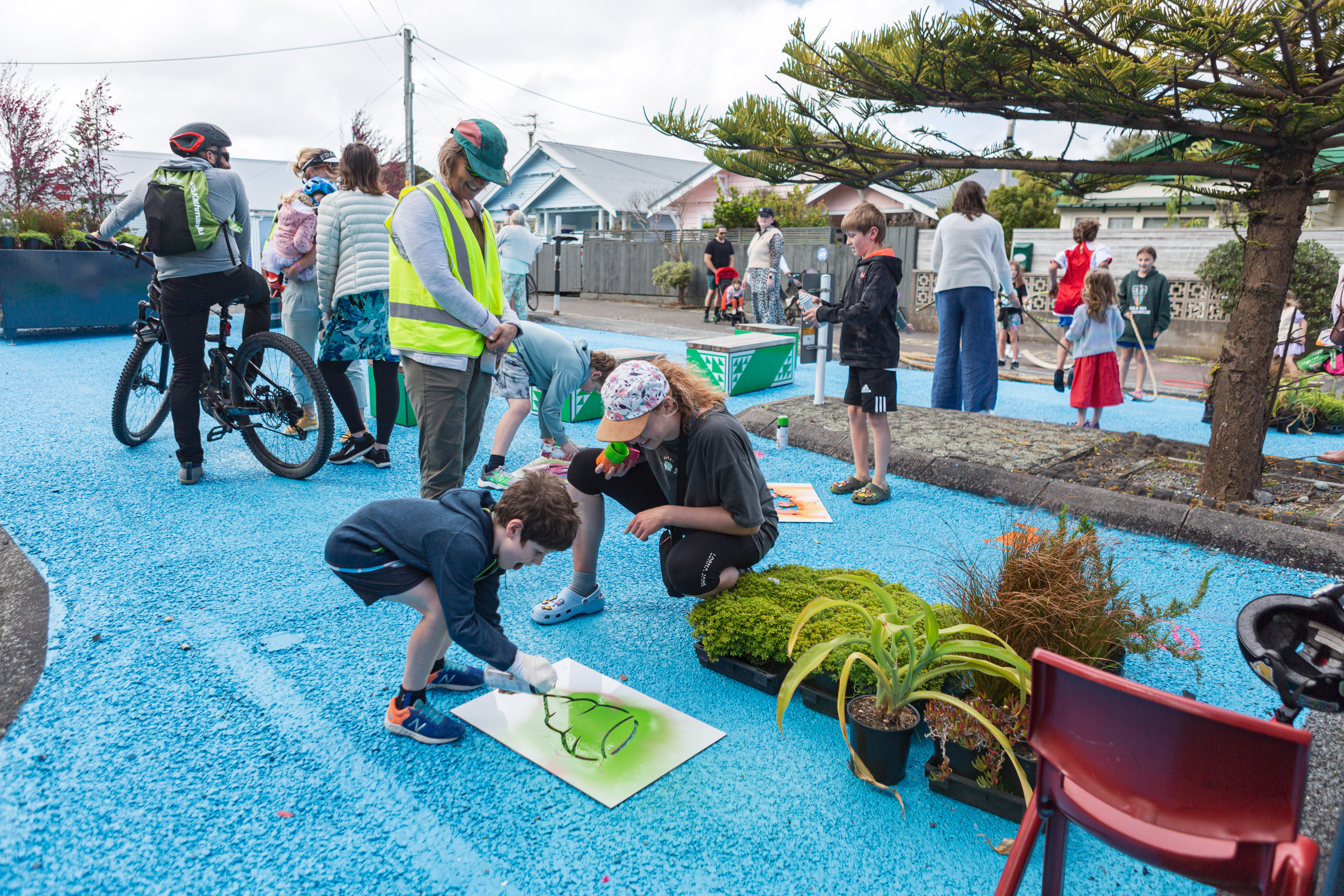 Child sprays seashell stencil
